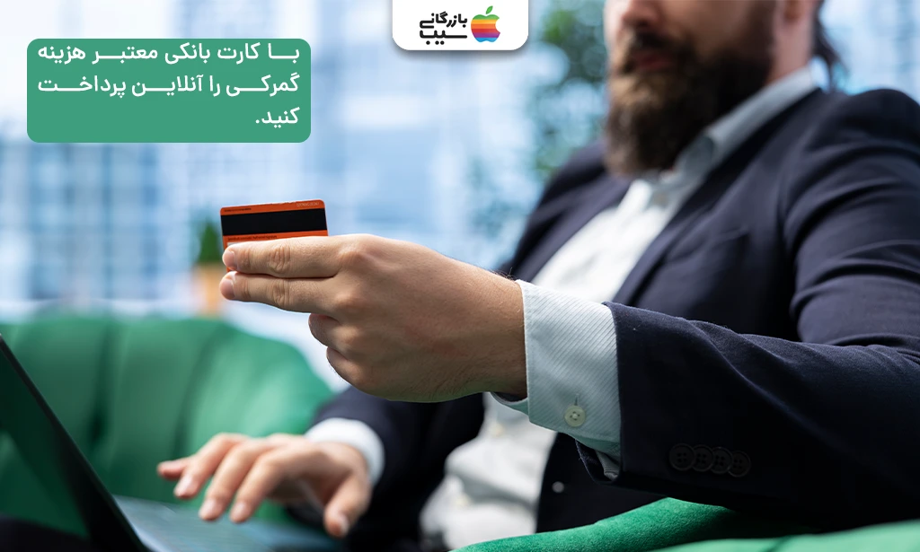 تصویری از یک مرد که در حال وارد کردن شماره کارت خود داخل لپ تاپ است